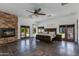 Spacious main bedroom suite with a stone fireplace, slate floors, and direct access to the outdoor space at 13238 N 78Th St, Scottsdale, AZ 85260