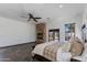 Inviting main bedroom featuring a fireplace, ceiling fan, and French doors leading to the pool at 13238 N 78Th St, Scottsdale, AZ 85260