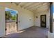 A covered outdoor patio features decorative concrete, ambient lighting, and access to an iron gate at 13238 N 78Th St, Scottsdale, AZ 85260