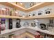 Well-organized pantry with custom shelving, countertop, and storage containers for easy access at 13238 N 78Th St, Scottsdale, AZ 85260