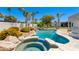 Beautiful backyard oasis with a sparkling pool, rock waterfall, and lush landscaping, creating a serene escape at 13238 N 78Th St, Scottsdale, AZ 85260
