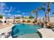 A pristine pool with a rock waterfall feature and inviting lounge chairs for relaxation under the sun at 13238 N 78Th St, Scottsdale, AZ 85260
