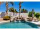 Refreshing pool area with a charming rock waterfall feature and swaying palm trees, ideal for outdoor enjoyment at 13238 N 78Th St, Scottsdale, AZ 85260