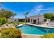 A stunning pool surrounded by lush landscaping, with a built-in barbecue and outdoor seating areas at 13238 N 78Th St, Scottsdale, AZ 85260