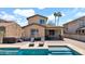 Stunning home exterior featuring a pool, lounge chairs, patio, and meticulously landscaped yard at 13256 N 153Rd Ln, Surprise, AZ 85379