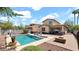 Backyard featuring a pool, fire pit, outdoor seating, and meticulously landscaped yard at 13256 N 153Rd Ln, Surprise, AZ 85379