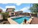 An outdoor oasis with a pool, lounge seating, and meticulously landscaped yard at 13256 N 153Rd Ln, Surprise, AZ 85379