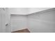 Walk-in closet with neutral carpet, white walls, and overhead shelving at 13256 N 153Rd Ln, Surprise, AZ 85379