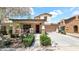 Charming two-story home featuring a covered porch, stone accents, and a well-manicured front yard at 13256 N 153Rd Ln, Surprise, AZ 85379