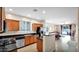 Open-concept kitchen with stainless steel appliances, dark countertops, and wood cabinetry, connected to dining at 13256 N 153Rd Ln, Surprise, AZ 85379