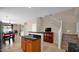 An open-concept kitchen flows to the living areas with stairs that lead to the upstairs bedrooms at 13256 N 153Rd Ln, Surprise, AZ 85379