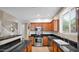 Well-equipped kitchen with stainless steel appliances, dark countertops, and wood cabinetry at 13256 N 153Rd Ln, Surprise, AZ 85379