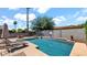 Enjoy the sparkling blue pool with lounge seating, a fire pit, and a basketball hoop at 13256 N 153Rd Ln, Surprise, AZ 85379