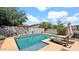 A refreshing swimming pool awaits, surrounded by lush greenery and stylish lounge chairs at 13256 N 153Rd Ln, Surprise, AZ 85379