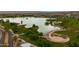 Expansive aerial shot of a picturesque lake surrounded by green landscapes and walking paths at 14254 N Boxwood Ln # 158B, Fountain Hills, AZ 85268