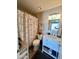 Updated bathroom with a shower, vanity, and floral-themed shower curtain, creating a cozy atmosphere at 14254 N Boxwood Ln # 158B, Fountain Hills, AZ 85268