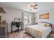 Bright bedroom featuring a comfortable bed, desk, and Southwestern-inspired artwork, creating a serene space at 14254 N Boxwood Ln # 158B, Fountain Hills, AZ 85268
