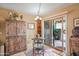 Charming breakfast nook with a table, chairs, and rustic wood cabinet, adjacent to a patio entrance at 14254 N Boxwood Ln # 158B, Fountain Hills, AZ 85268
