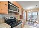 Well-equipped kitchen with modern appliances, light wood cabinetry, and an adjoining breakfast nook at 14254 N Boxwood Ln # 158B, Fountain Hills, AZ 85268