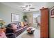 Comfortable living room with a leather couch, decorative ladder, ceiling fan, and a rustic coffee table at 14254 N Boxwood Ln # 158B, Fountain Hills, AZ 85268