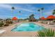 Sunny community pool with umbrellas, seating, and palm trees provides a refreshing escape at 14254 N Boxwood Ln # 158B, Fountain Hills, AZ 85268