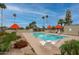 Community pool with lounge chairs, umbrellas, and lush landscaping offers a relaxing retreat at 14254 N Boxwood Ln # 158B, Fountain Hills, AZ 85268