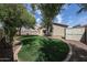 Backyard features green grass with mature trees, gravel, privacy walls and a shed at 14262 N 142Nd Ln, Surprise, AZ 85379