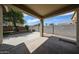 Covered patio area in the backyard featuring a concrete slab and block wall fencing at 14262 N 142Nd Ln, Surprise, AZ 85379
