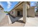 Exterior shot of backyard with covered patio, gravel landscaping and block wall at 14262 N 142Nd Ln, Surprise, AZ 85379