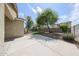 Spacious backyard with a grassy area, shade trees, and block wall fencing at 14262 N 142Nd Ln, Surprise, AZ 85379