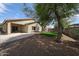 A nice backyard with a concrete patio, well-kept lawn area, and mature trees offering shade at 14262 N 142Nd Ln, Surprise, AZ 85379