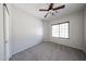 Bedroom features neutral colored walls, a ceiling fan, carpeted floors, and a window at 14262 N 142Nd Ln, Surprise, AZ 85379