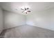 Large empty bedroom with a ceiling fan, neutral walls, and plush carpeting at 14262 N 142Nd Ln, Surprise, AZ 85379