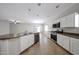 Bright kitchen features white cabinets, stainless steel appliances, and a large island at 14262 N 142Nd Ln, Surprise, AZ 85379