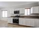 Bright kitchen features white cabinets, stainless steel appliances, and tile flooring at 14262 N 142Nd Ln, Surprise, AZ 85379