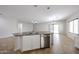 Kitchen island features a stainless steel dishwasher and double sink at 14262 N 142Nd Ln, Surprise, AZ 85379