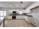 Well-lit kitchen boasting white cabinets, stainless steel appliances, and tile flooring at 14262 N 142Nd Ln, Surprise, AZ 85379