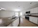 Bright kitchen features white cabinets, stainless steel appliances, and a large island with a double sink at 14262 N 142Nd Ln, Surprise, AZ 85379