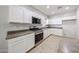 Well-equipped kitchen with white cabinetry, modern stainless steel appliances and ample counter space at 14262 N 142Nd Ln, Surprise, AZ 85379