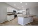Bright kitchen featuring white cabinets, a kitchen island, stainless steel appliances, and tile floors at 14262 N 142Nd Ln, Surprise, AZ 85379