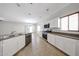 Open kitchen features white cabinets, stainless steel appliances, and tile flooring at 14262 N 142Nd Ln, Surprise, AZ 85379