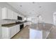 Modern kitchen with white cabinetry, stainless steel appliances, and a central island, perfect for cooking and entertaining at 14262 N 142Nd Ln, Surprise, AZ 85379