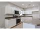 Bright kitchen featuring white cabinets, stainless steel appliances, and stylish countertops at 14262 N 142Nd Ln, Surprise, AZ 85379