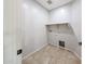 Bright laundry room features tile flooring and a shelf at 14262 N 142Nd Ln, Surprise, AZ 85379