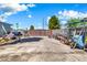 Wide backyard featuring secure metal gate and ample storage for various yard tools at 1451 E Brown Rd, Mesa, AZ 85203