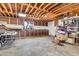 Spacious unfinished basement providing ample storage or customization opportunities with exposed wood rafters at 1451 E Brown Rd, Mesa, AZ 85203