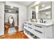 Bright bathroom features a double vanity, modern fixtures, and a walk-in closet for ample storage at 1451 E Brown Rd, Mesa, AZ 85203