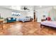 Bright bedroom with ceiling fan, tile flooring, backyard view, and multiple beds for a growing Gathering at 1451 E Brown Rd, Mesa, AZ 85203