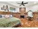 Bedroom featuring a brick fireplace, vanity area, and tiled floors at 1451 E Brown Rd, Mesa, AZ 85203