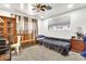 Cozy bedroom featuring neutral tones, comfortable seating, and a ceiling fan for added comfort at 1451 E Brown Rd, Mesa, AZ 85203